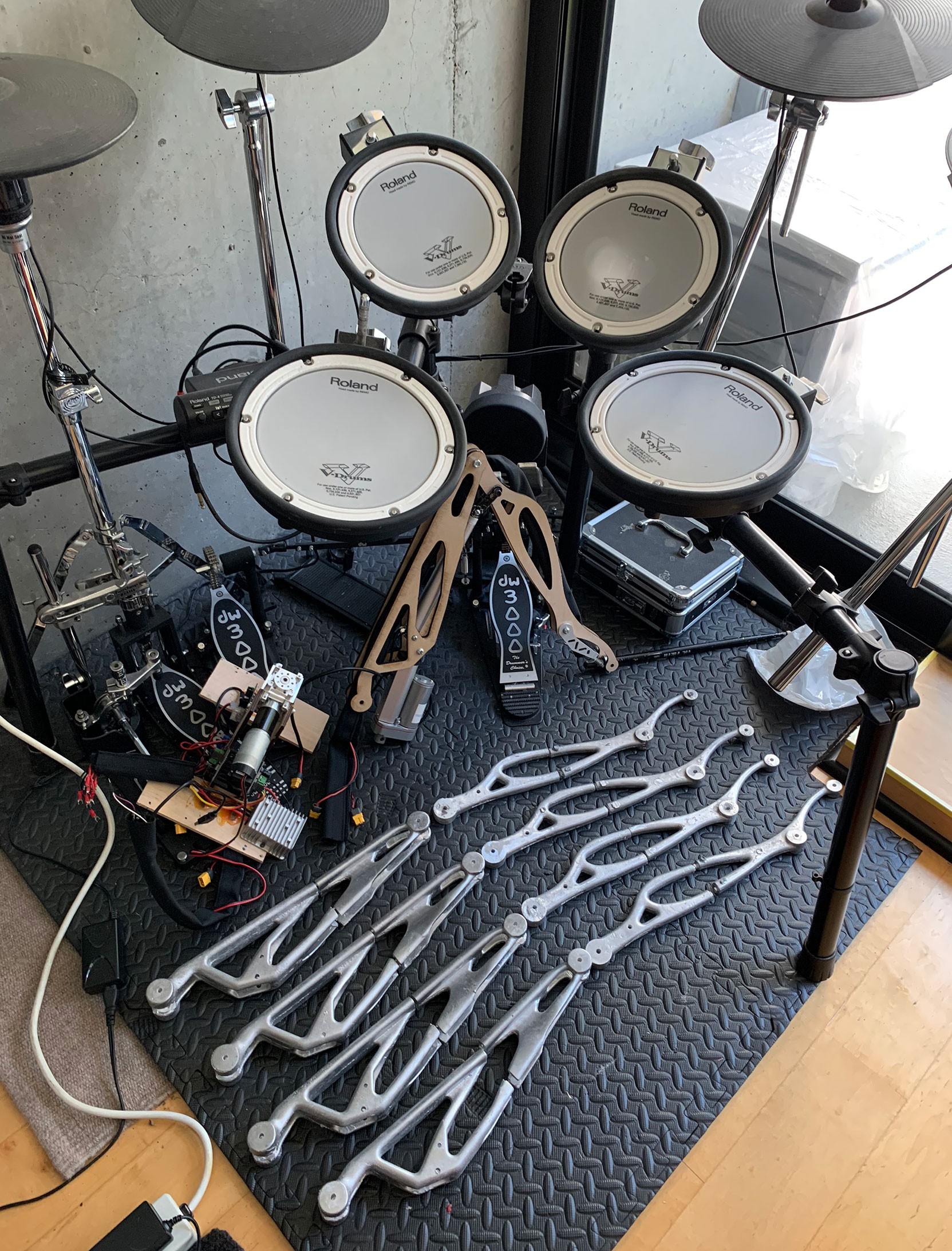 Robot arms next to drum kit