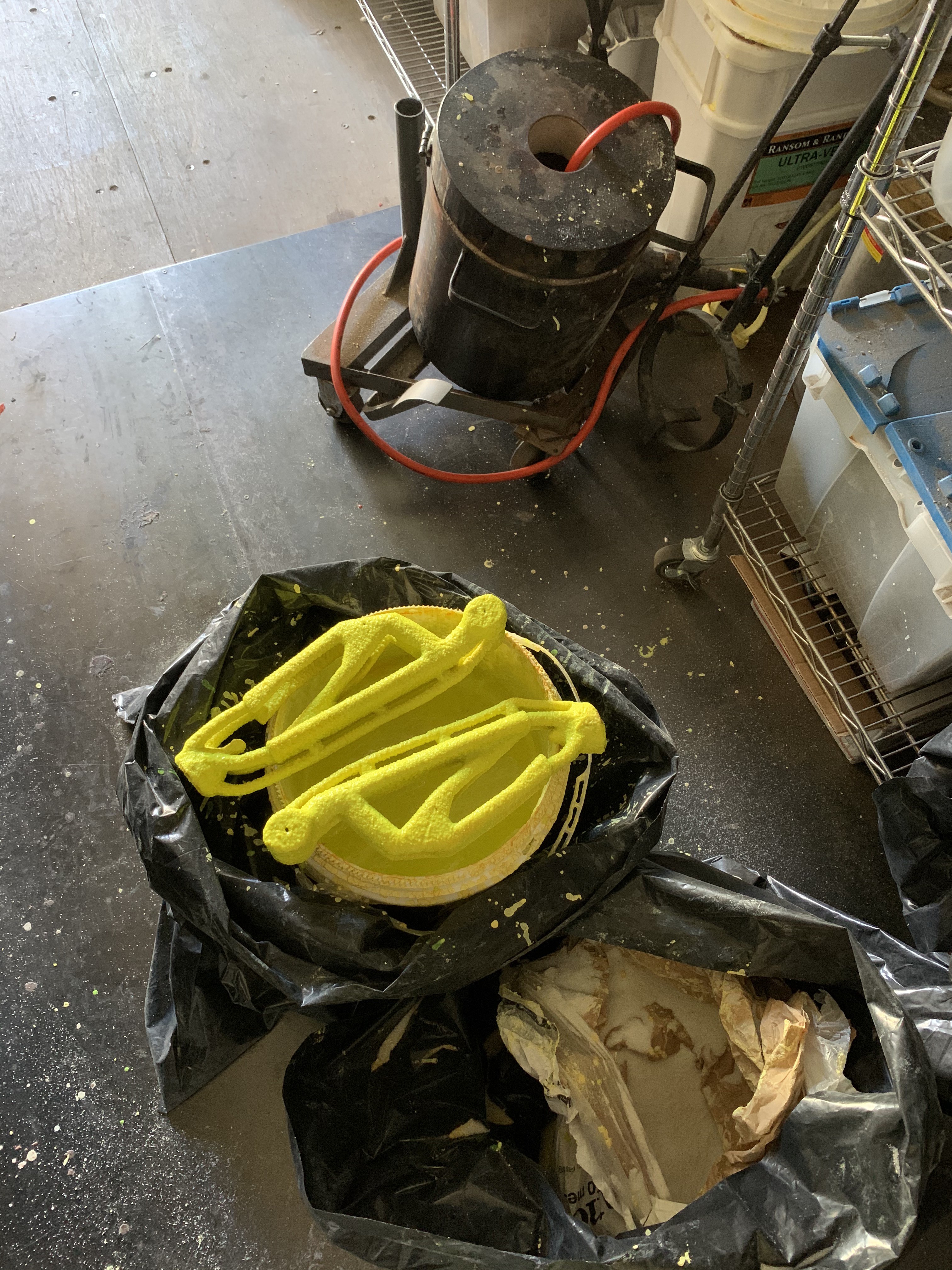Upper arms on bucket of slurry with kiln